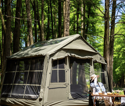 Olive SEKACAMP Square Air Tent 8 at a campsite with outdoor furniture