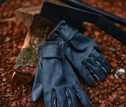 TOKYO CRAFTS Camp Leather Gloves – gloves resting beside camp tools